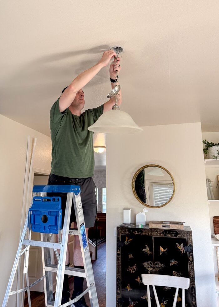 Greg hanging up a light fixture