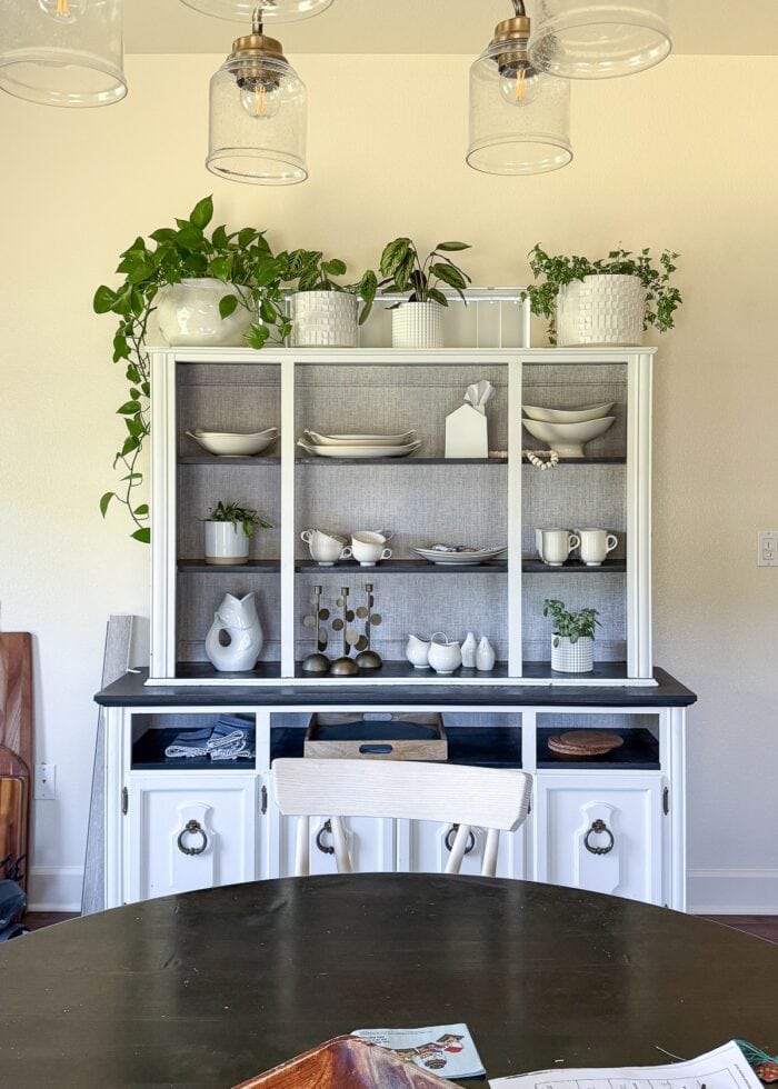 A dining hutch in front of a window