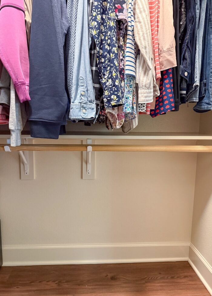 A closet with nothing hanging on the bottom rod