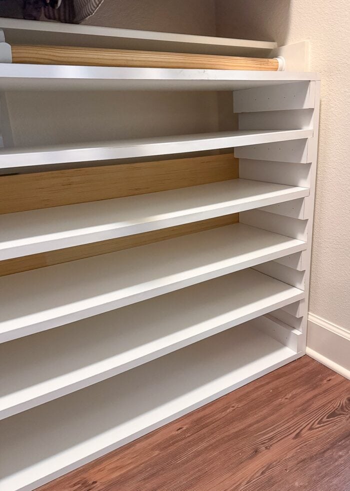 A simple white DIY shoe shelf without any shoes on the shelves