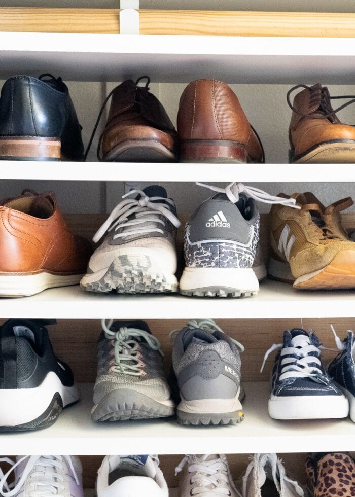 A variety of men's and women's shoes on a DIY shoe storage shelf