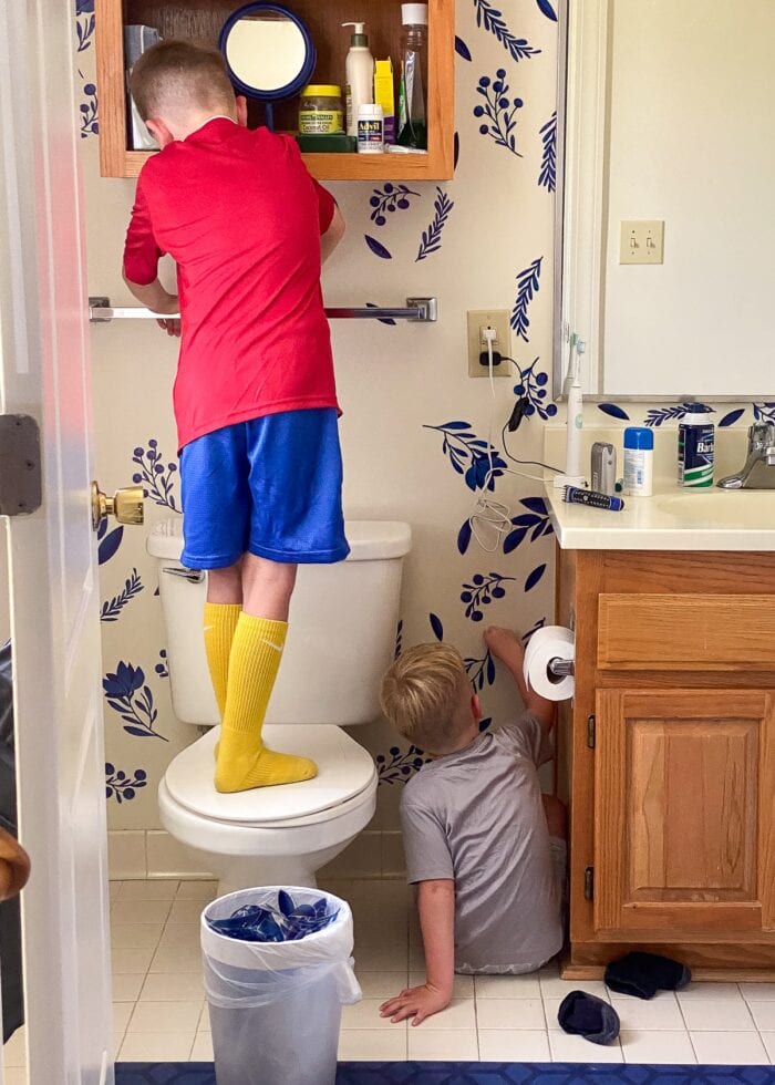 Kids removing bathroom decals off the wall