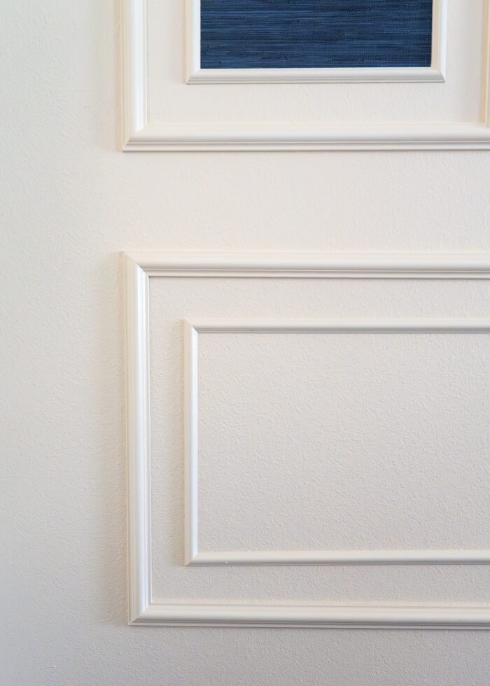 A close-up shot of PVC trim moulding installed as frames on an ivory wall
