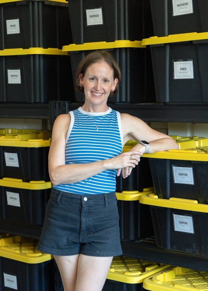Megan from The Homes I Have Made standing in front of a shelf full of HDX bins.