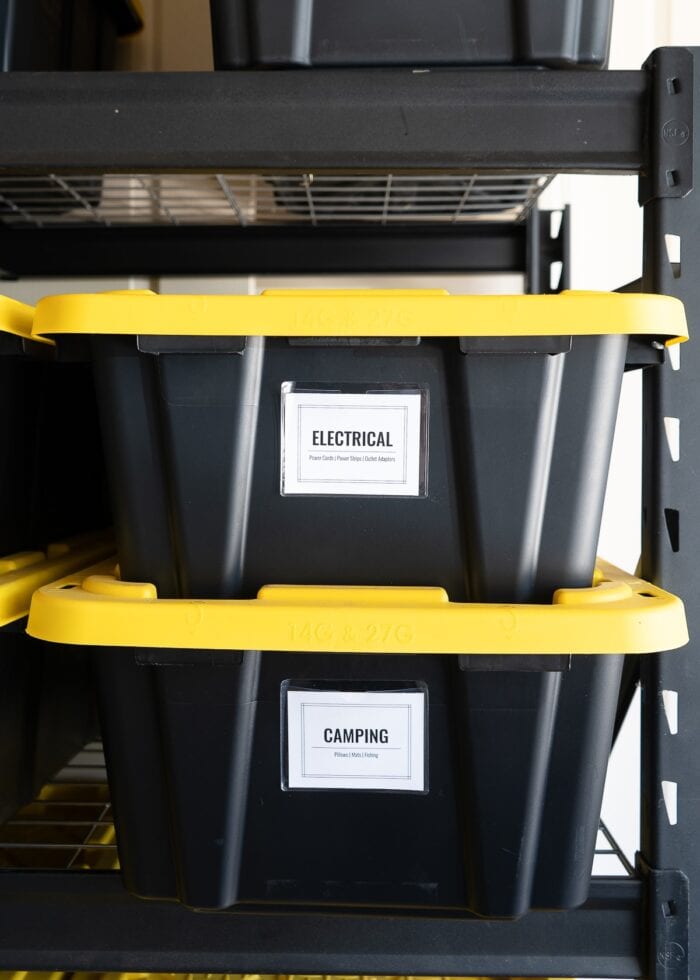 14 gallon HDX bins on a black shelf with large white labels.