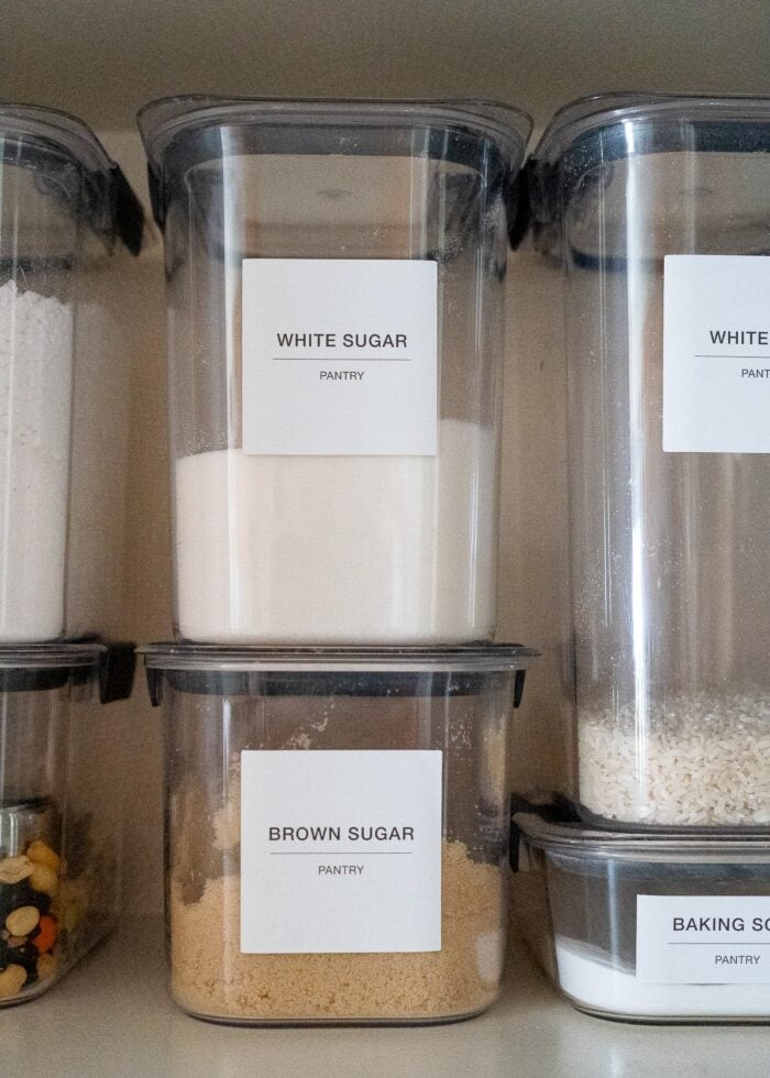 Rubbermaid Brilliance Pantry Canisters with big white labels on a pantry shelf
