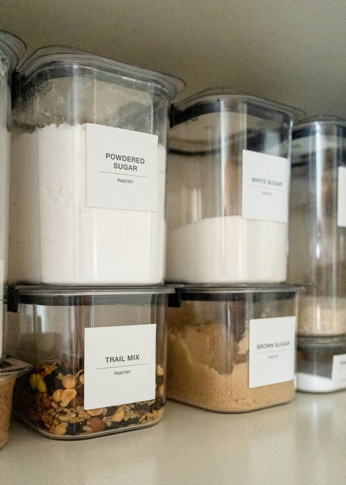 Rubbermaid Brilliance Pantry Canisters with big white labels on a pantry shelf