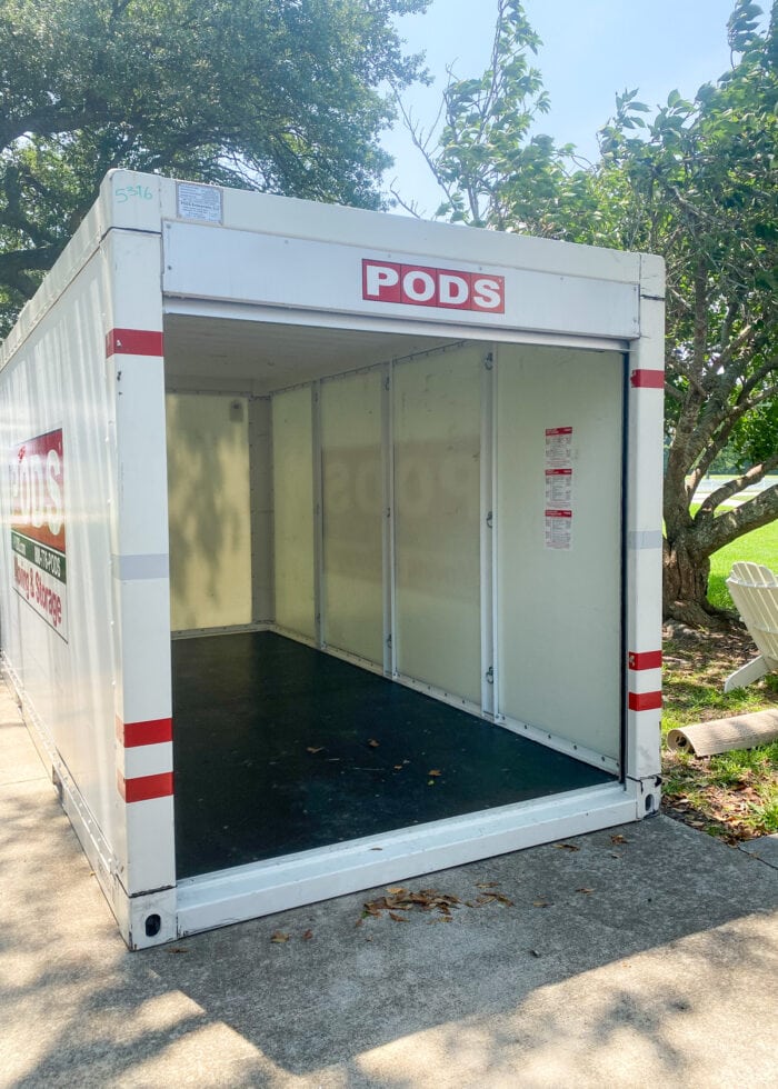 An empty PODS container sitting on a driveway