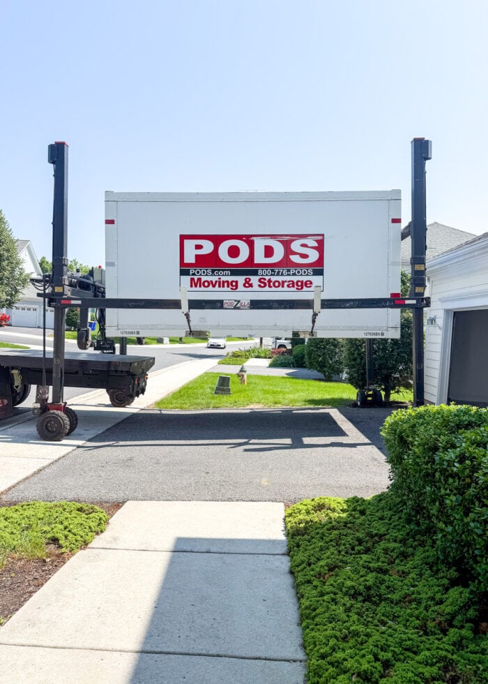 A PODS container lifted on the PODS-Zilla for placement.