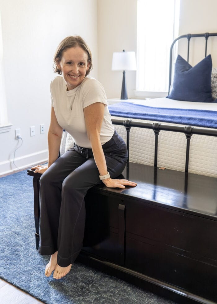 Megan from The Homes I Have Made sitting on a painted black cedar chest