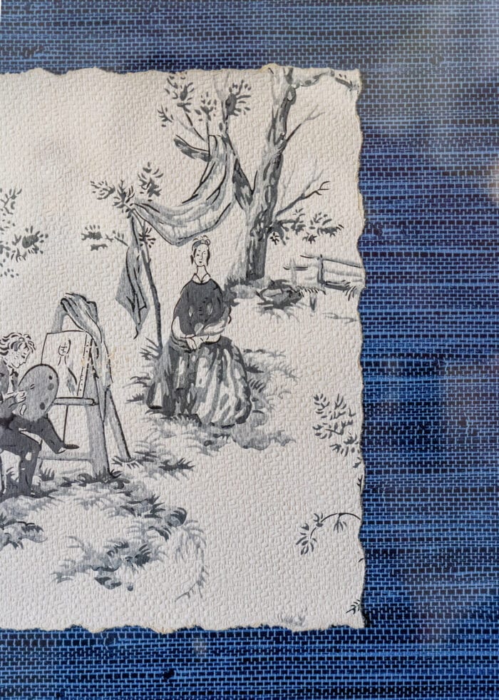 A scrap of vintage French wallpaper in a frame matted with blue grasscloth