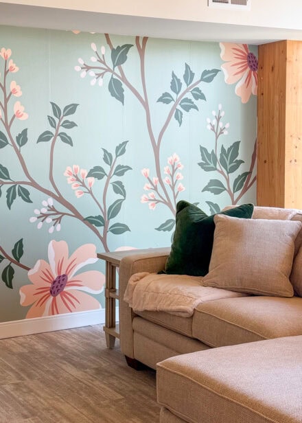 A beautiful peach and mint floral mural hung on an apartment wall.