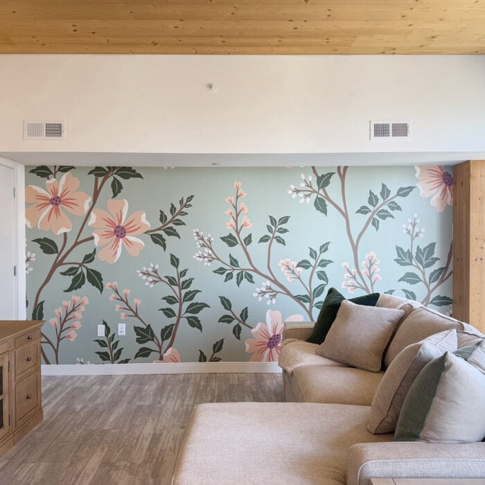 A beautiful peach and mint floral mural hung on an apartment wall.