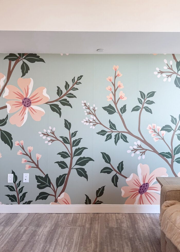 A beautiful peach and mint floral mural hung on an apartment wall.