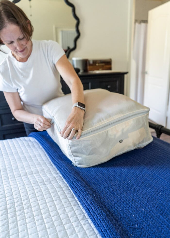 Megan zipping a compression sack shut