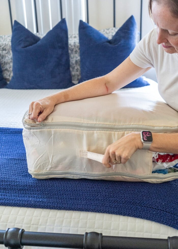 Megan zipping a compression sack shut
