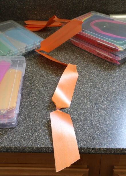 An orange pull bow unfurled on a counter