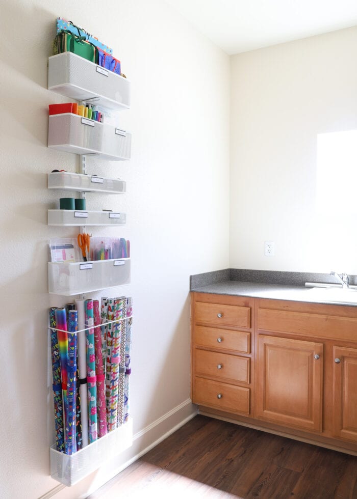 A Elfa storage system mounted to a wall in a laundry room
