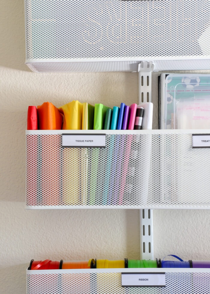 A rainbow assortment of tissue paper in a large Elfa basket